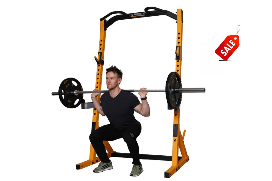 Yellow and black half rack with man performing barbell squat, loaded with black weight plates, on white background