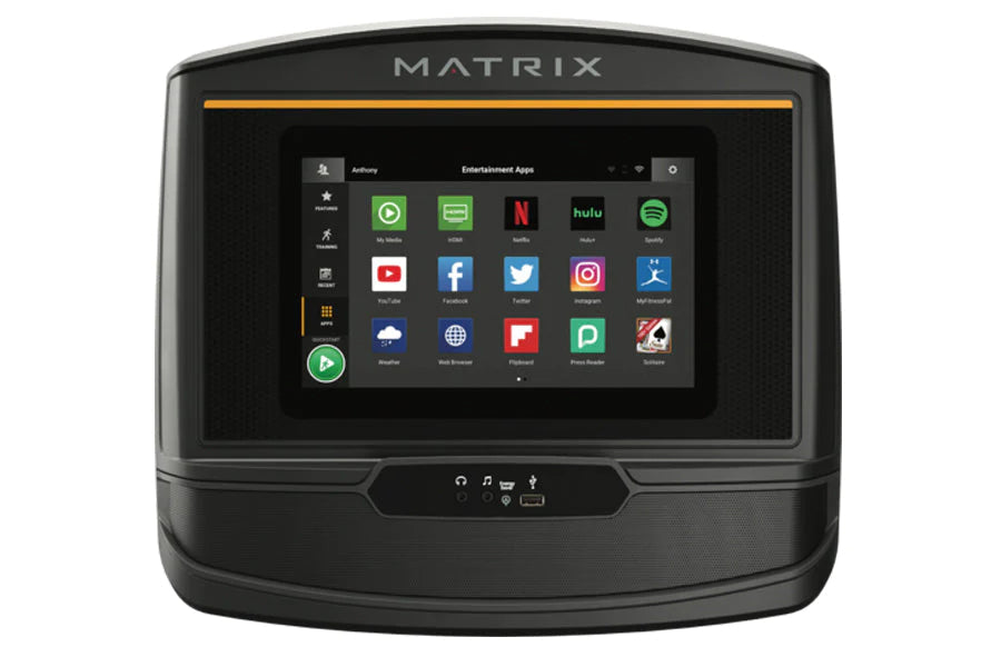 Matrix TF50 folding treadmill console displaying entertainment apps on touchscreen with orange accent stripe, front view on w