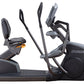 Octane XR6000 recumbent exercise bike with black frame, padded seat and backrest, dual handle bars, and foot pedals on white 