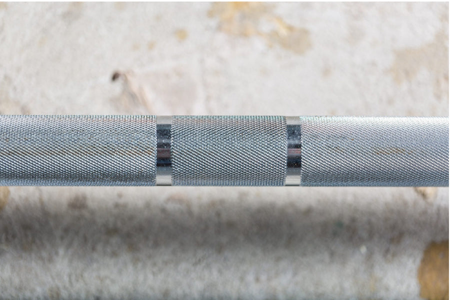 York Elite Power Bar with gray knurled grip and black binding straps, close-up detail view