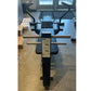 Black and silver commercial abdominal bench with curved handles and foot pedal, viewed from above in gym setting