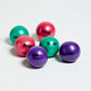 Set of five Aeromat mini weight balls in pink, purple, and teal with glossy finish on white background