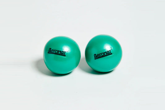 Pair of turquoise Aeromat mini weight balls with black branding, on white background