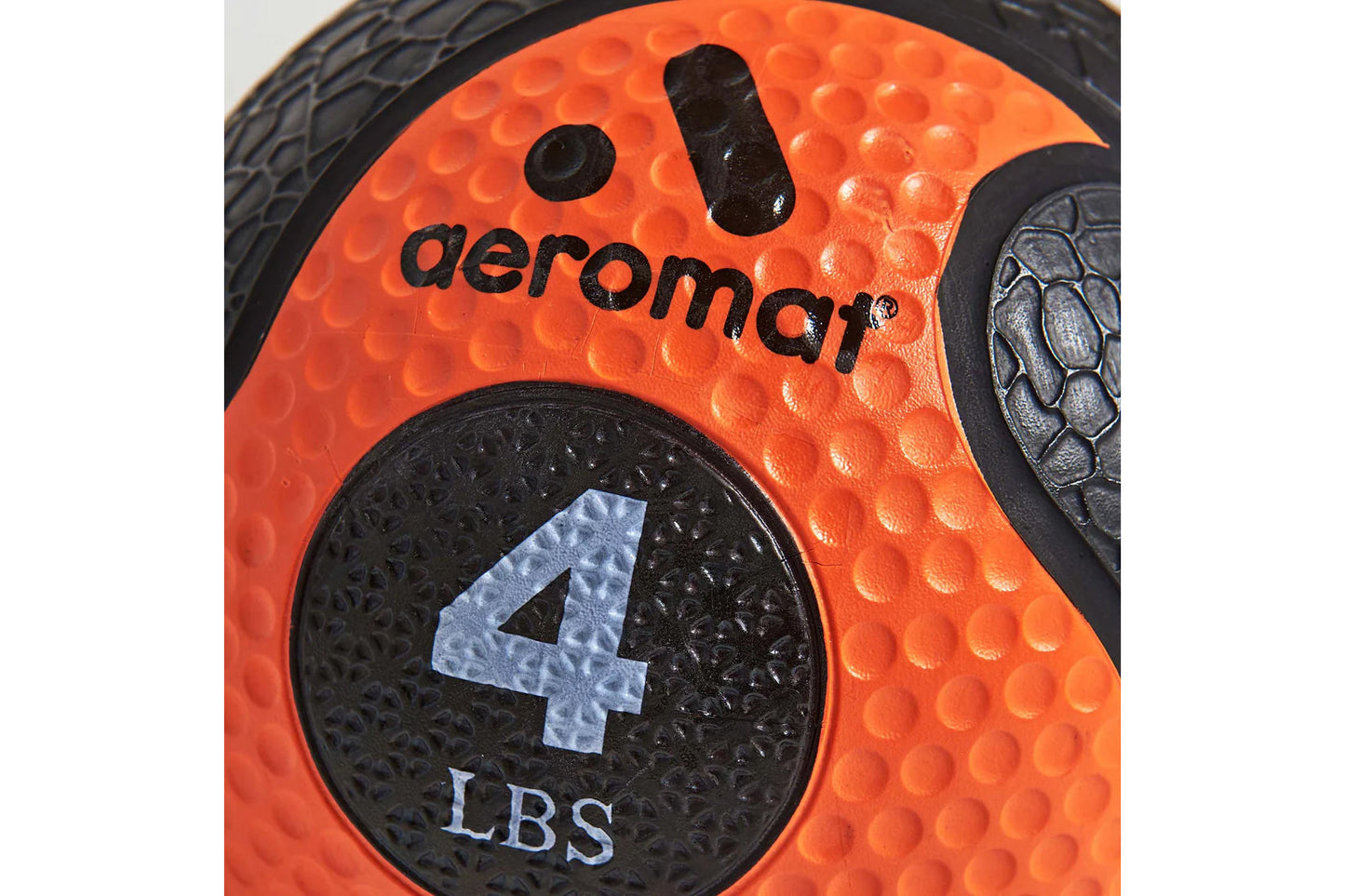 Aeromat bright orange medicine ball with textured surface, black accents, and 4 LBS weight marking in center panel