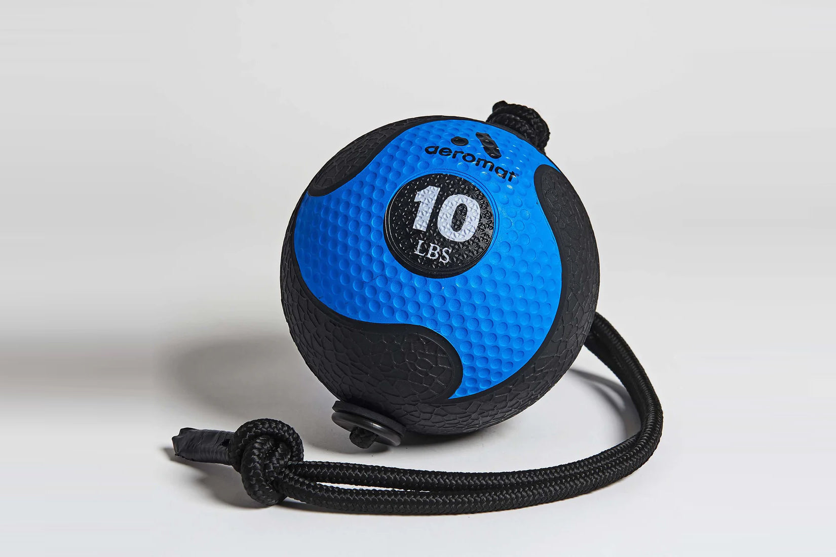 Aeromat 10 LBS medicine ball with blue textured surface, black panels, and attached black rope handle on white background