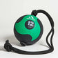 Aeromat 12-lb medicine ball in green and black with textured rubber surface and black rope handle, flat lay on white backgrou