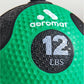 Aeromat 12 lbs green medicine ball with textured grip and black rope handles on white background