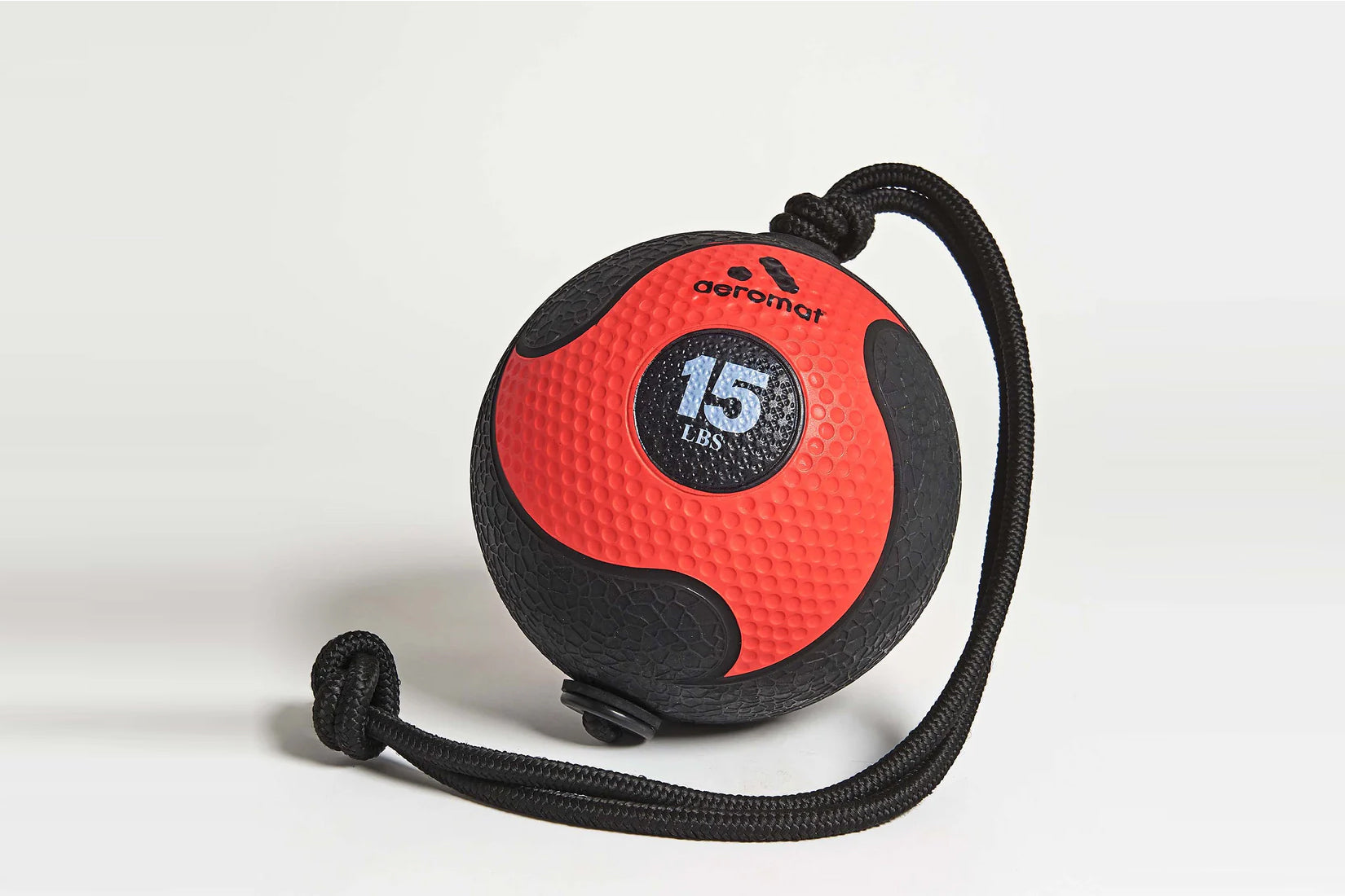 Aeromat 75-pound medicine ball in red and black with attached rope handle on white background