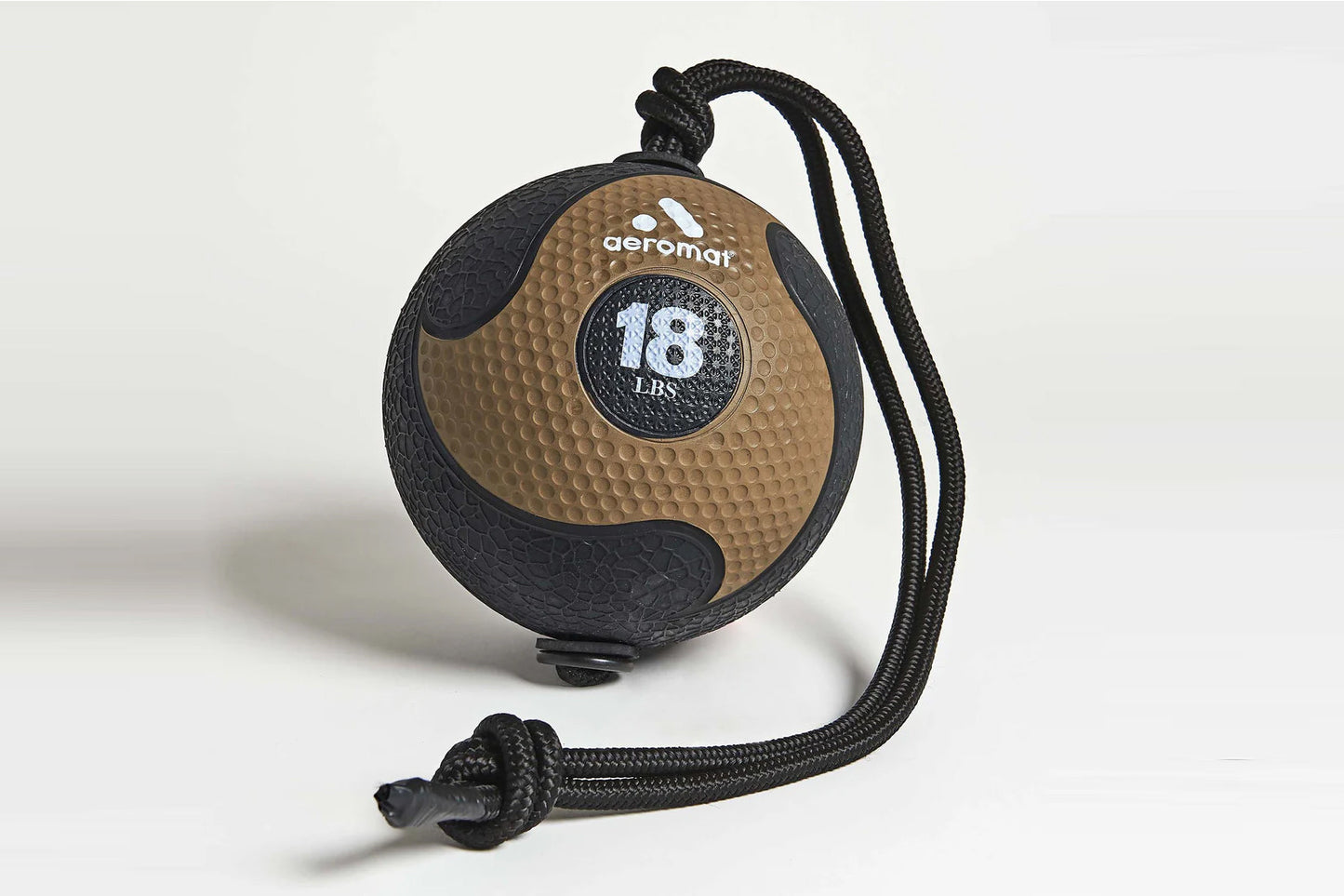 Aeromat 18 lbs medicine ball with tan textured surface, black trim, and black rope attachment on white background