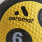 Aeromat yellow medicine ball with textured grip pattern and black branding detail, close-up view