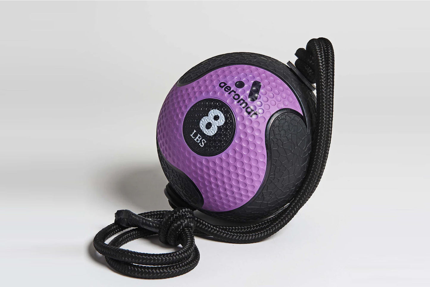 Purple and black medicine ball with textured grip, labeled 8 LBS, attached to black braided rope on white background