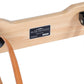 Natural wood Pilates reformer with Peak Pilates nameplate, tan leather straps, and black adjustment hardware on white backgro