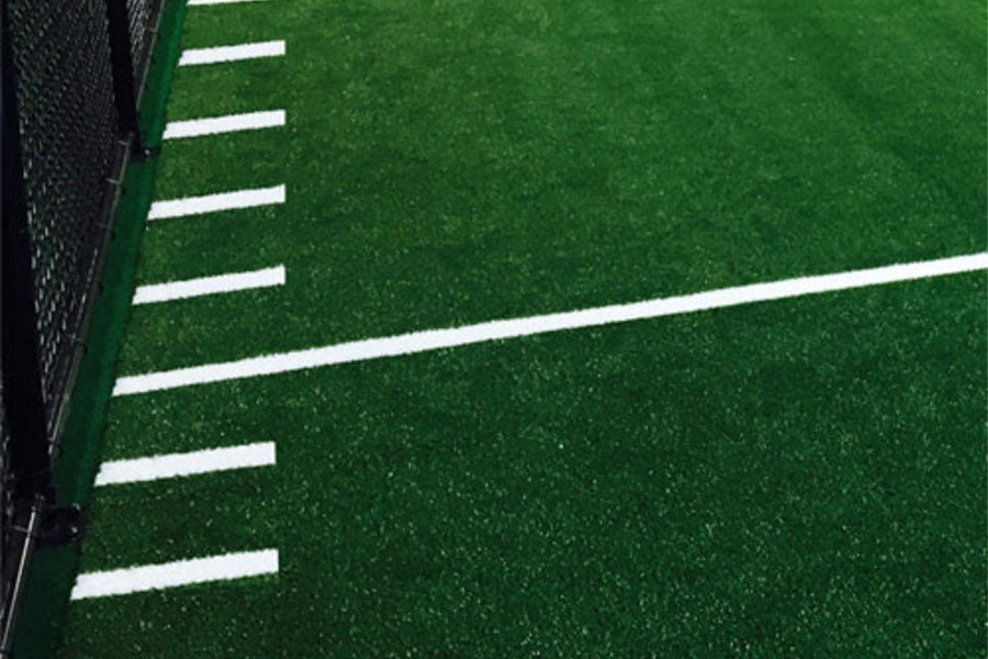 Warrior Agility Turf artificial grass with white yard line markings and numbers on green field
