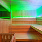 Modern sauna interior with wooden benches, vertical wood paneling, and color-changing LED lighting transitioning from green t