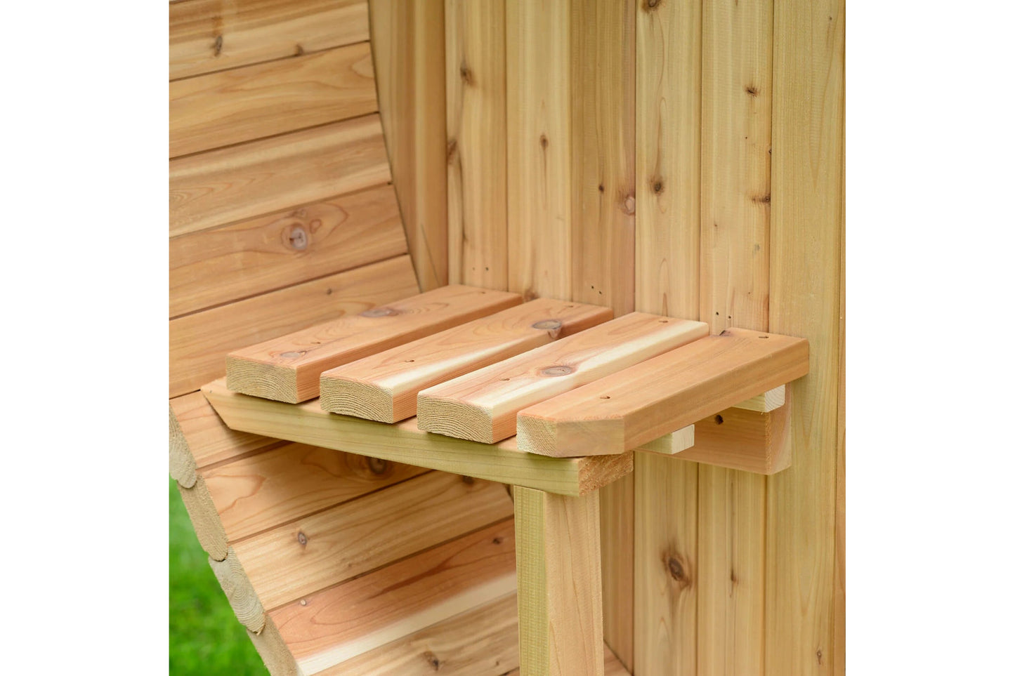 Natural wood sauna interior with wooden bench seating and four cylindrical headrest pillows, showing construction details