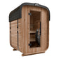 Cedar wood sauna with black metal roof and glass door, featuring interior benches and heater, on white background