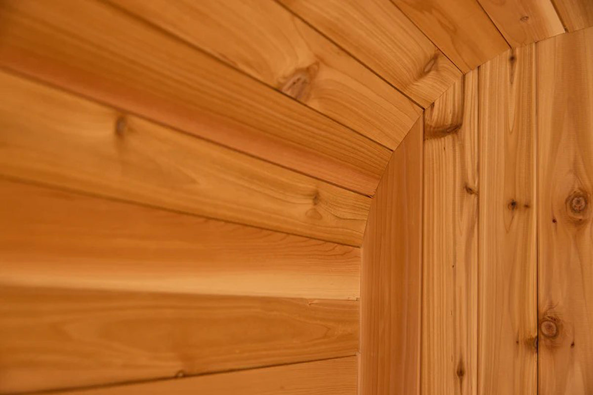 Cedar wood interior corner of sauna showing horizontal log walls and vertical post construction