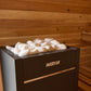 Harvia black sauna heater with white stones on top, positioned in wooden sauna room with benches