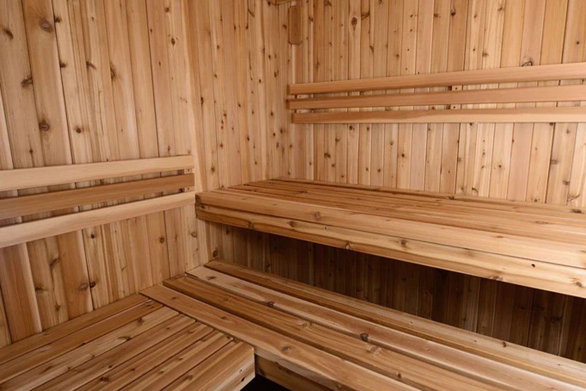 Almost Heaven Bridgeport 6-person indoor sauna interior with light wood construction, multiple tiered benches, and vertical w