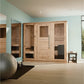Light natural wood 6-person indoor sauna with glass and wood panel doors, installed in mint green room with wooden flooring