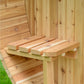 Natural wood sauna interior with wooden bench seating and backrest rails inside cedar structure