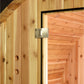 Natural pine wood sauna exterior with metal hinge detail on cedar door frame