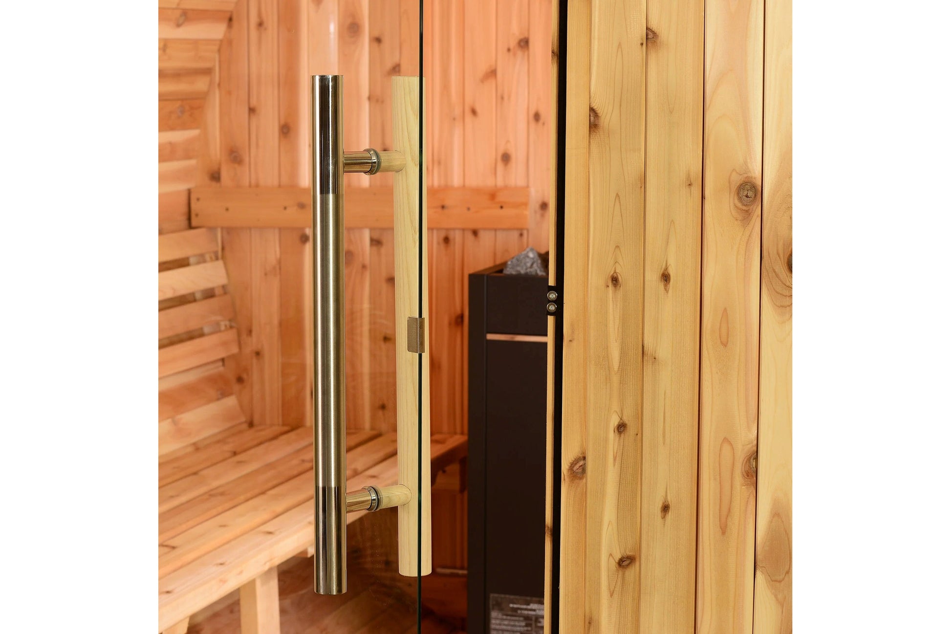 Glass sauna door with stainless steel pull handle and brass hardware on wooden barrel sauna interior
