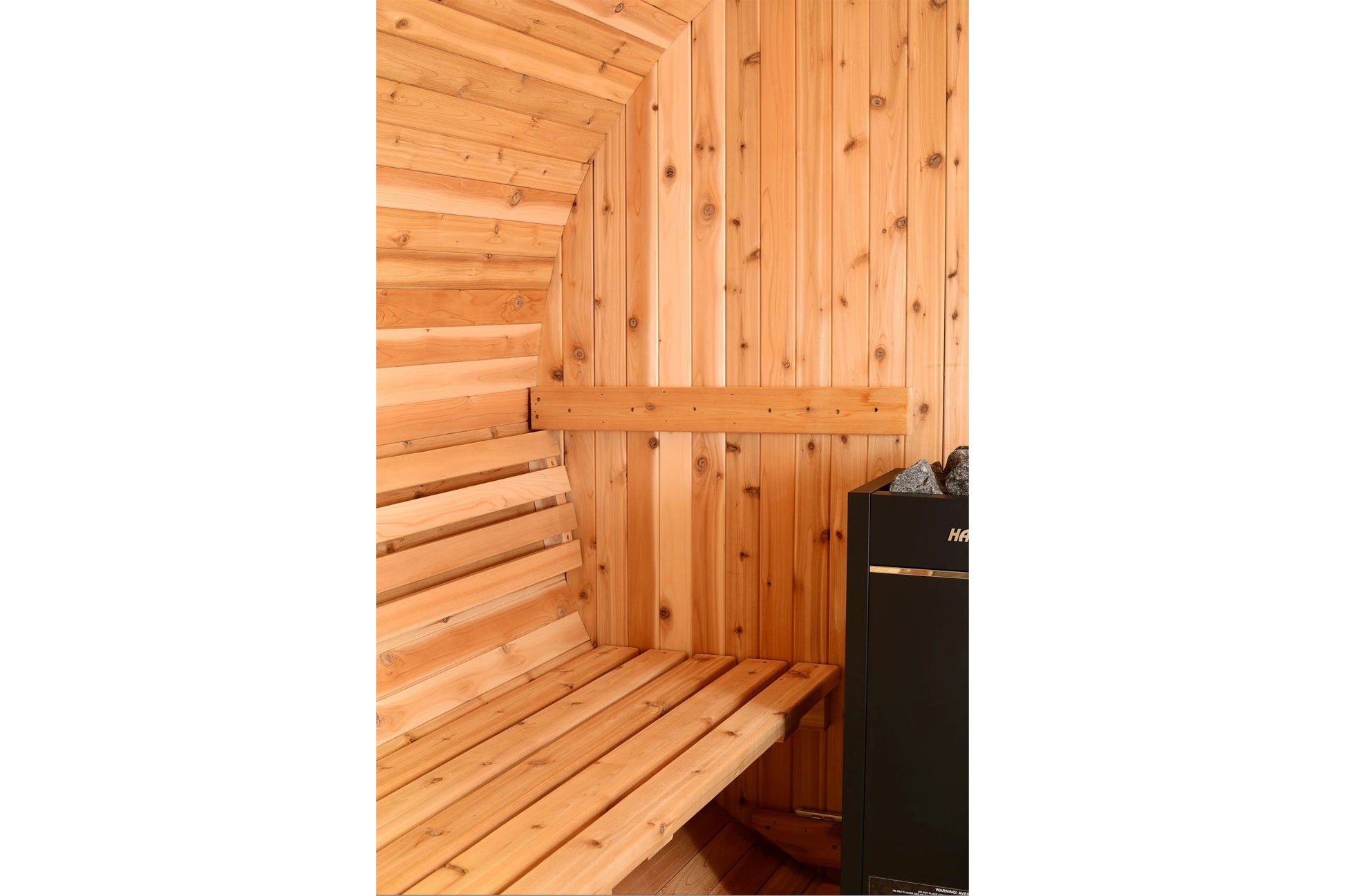 Almost Heaven Essex barrel sauna interior with light wood benches and walls, black heater visible on right