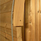 Natural wood barrel sauna exterior showing tongue-and-groove cedar planks with visible grain and knots, flat lay