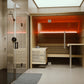 Almost Heaven Everwood indoor sauna with orange ceiling, wooden benches, glass doors and chrome handles in spa bathroom setti