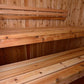 Cedar wood sauna interior with tiered wooden benches and backrest rails, flat lay view