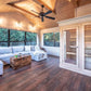 Modern sauna room with light wood interior, glass doors, and cedar benches visible inside adjacent to a living area with blue
