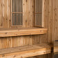 Cedar wood sauna interior with benches, ventilation grates, and glass-panel doors on light wood walls