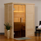 Natural pine wood sauna with glass door and interior lighting, featuring wooden benches, positioned in home interior with dec