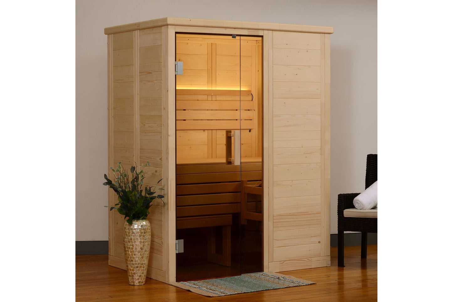 Natural pine wood sauna with glass door and interior lighting, featuring wooden benches, positioned in home interior with dec