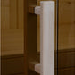 Light natural wood cylindrical door pull on glass sauna door