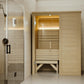 Almost Heaven Hillsboro 2-person indoor sauna with light wood construction, glass door, and bench seating, adjacent to shower