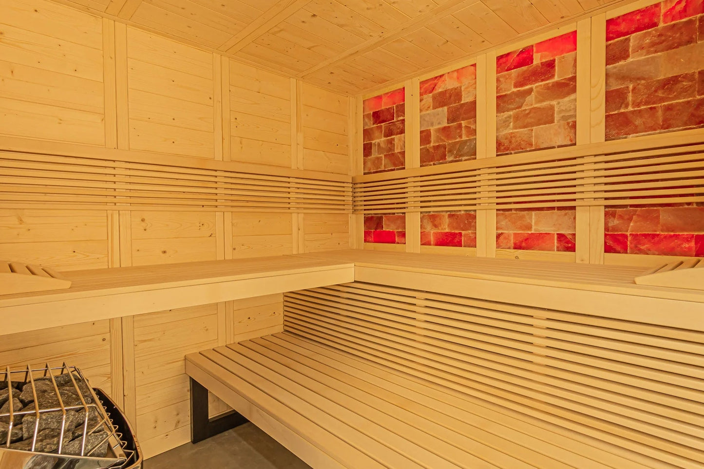 Almost Heaven Himalaya indoor sauna interior with light pine wood benches, horizontal slats, red salt brick windows, and meta