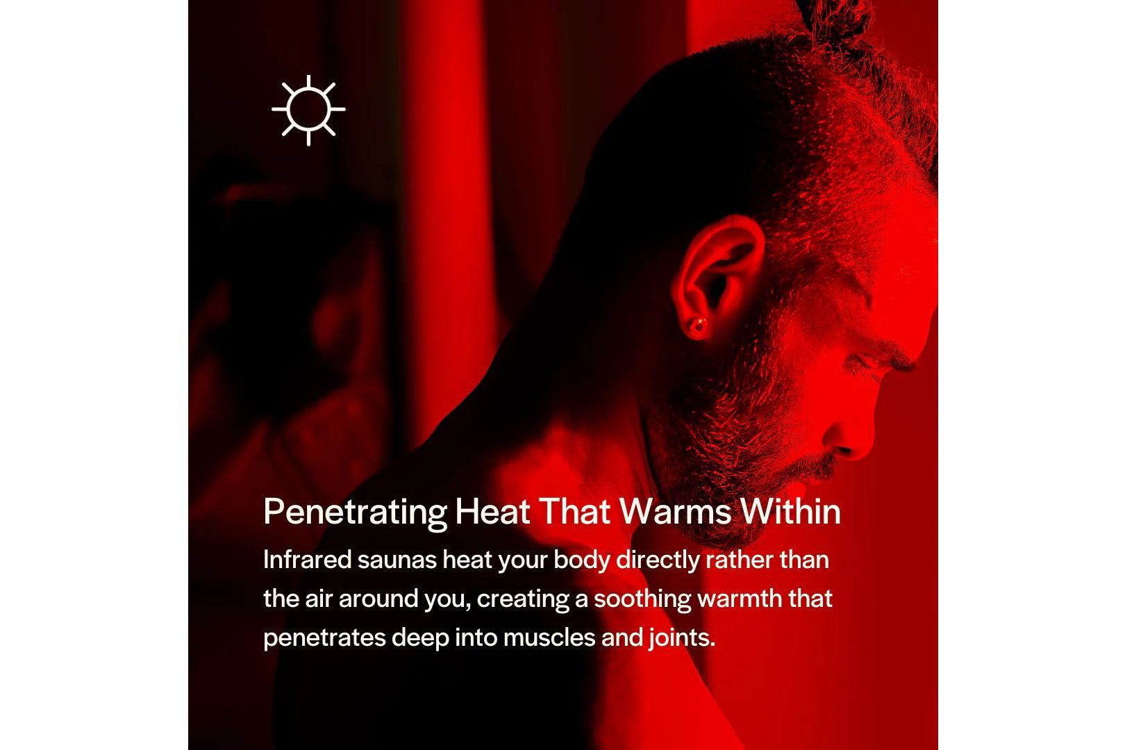 Man with beard in profile, bathed in red infrared heat lighting inside sauna
