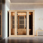 Almost Heaven Hinton 2-3 person infrared indoor sauna with light wood frame and vertical slat doors in modern spa setting