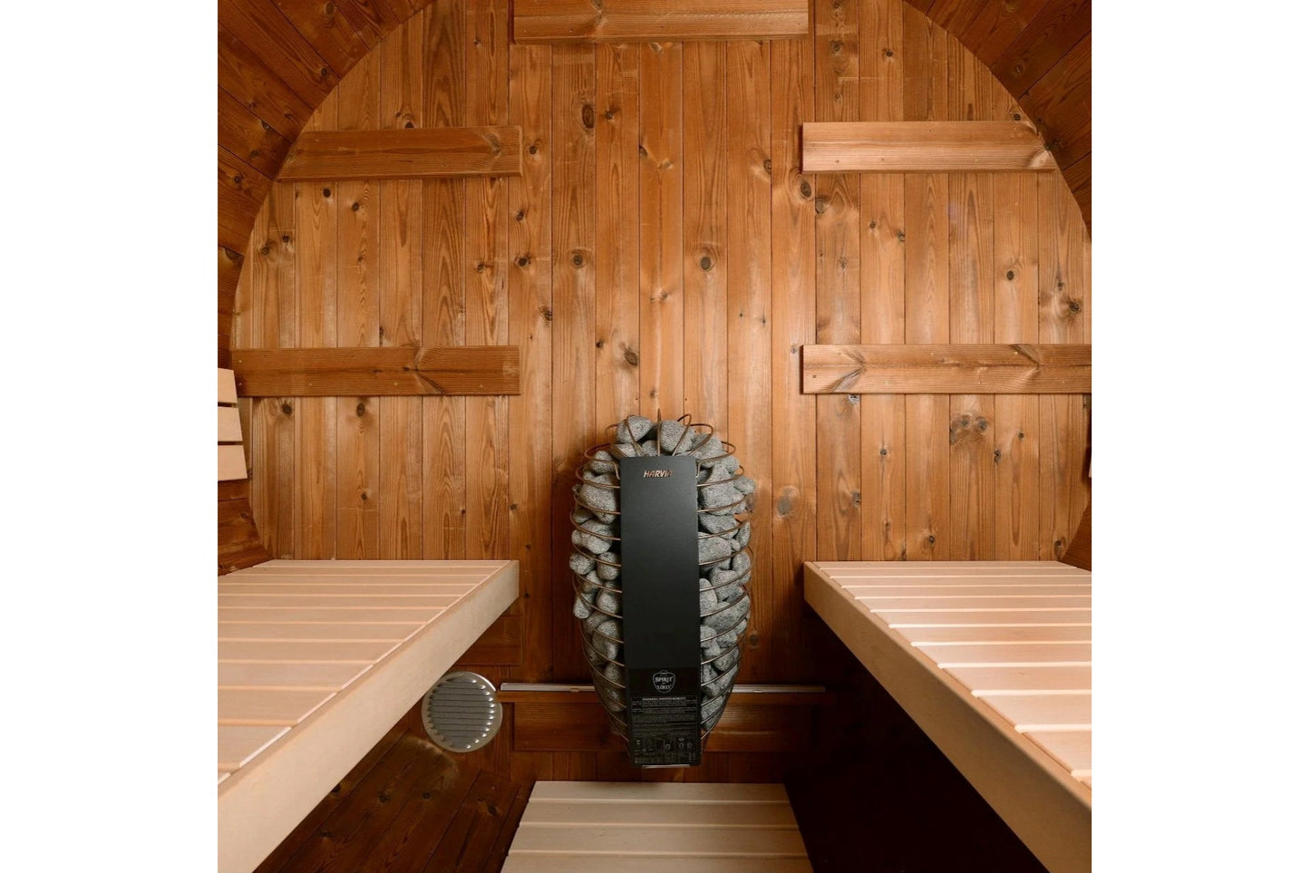 Overhead view of sauna interior with knotty pine wood walls, two wooden benches on either side, and black Kuuma heater stove 