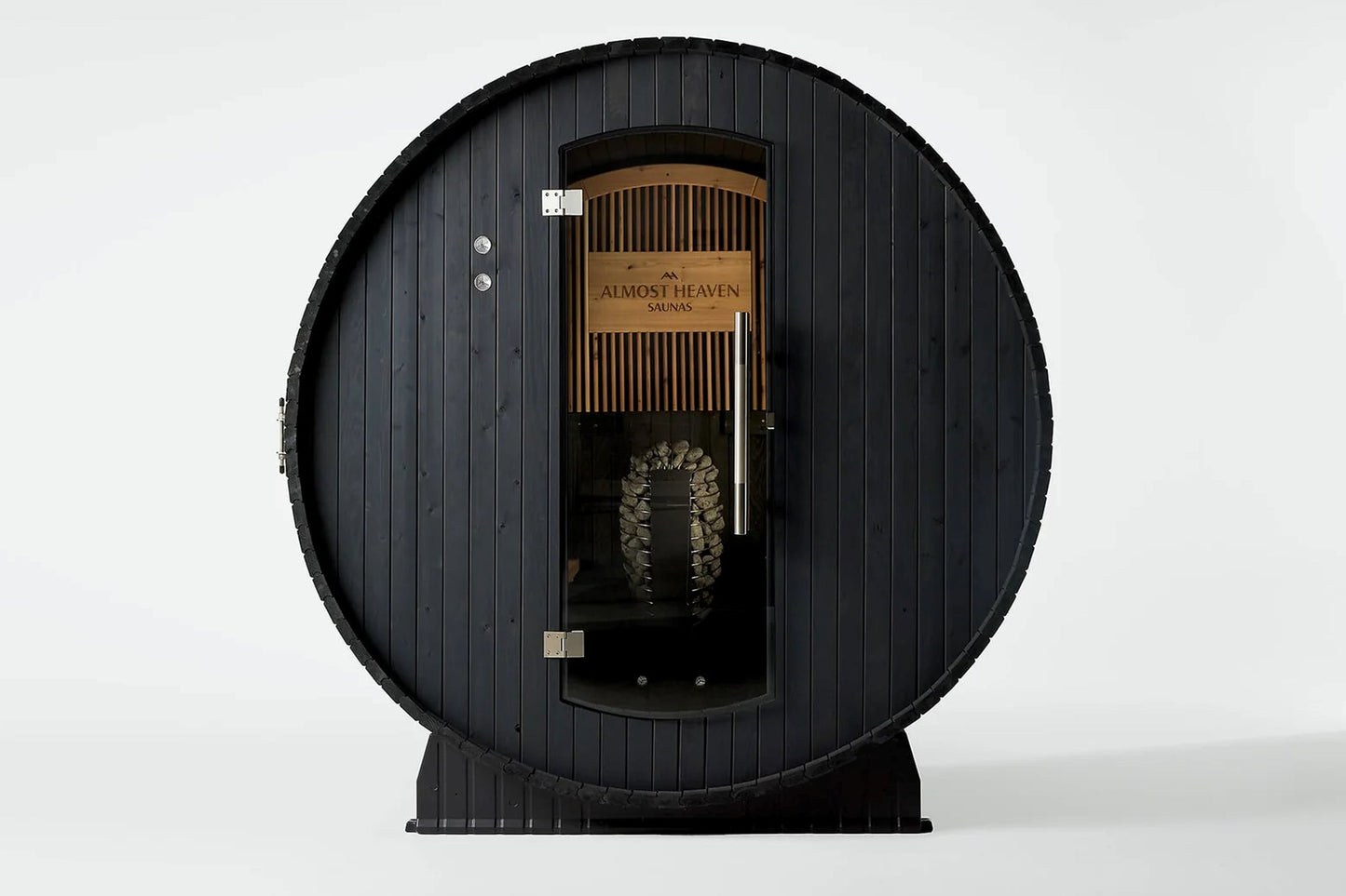 Black barrel sauna with wood interior, "Almost Heaven Saunas" branding, metal door, and visible heater stones on white backgr