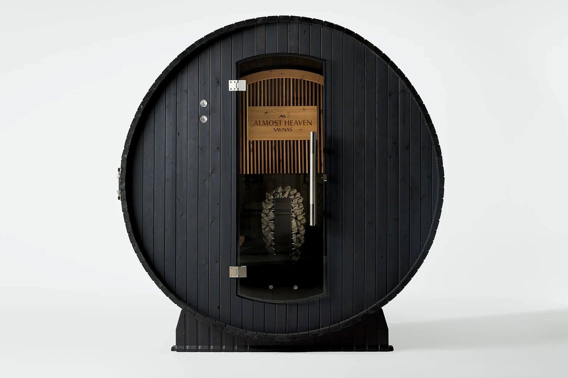 Black barrel sauna with wood interior, "Almost Heaven Saunas" branding, metal door, and visible heater stones on white backgr