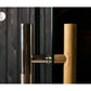 Polished chrome and wooden barrel sauna door handle with cylindrical push mechanism mounted on light oak wood door frame