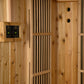 Cedar wood sauna interior with dual digital temperature controls, ventilation slats, and two circular air vents on the right 
