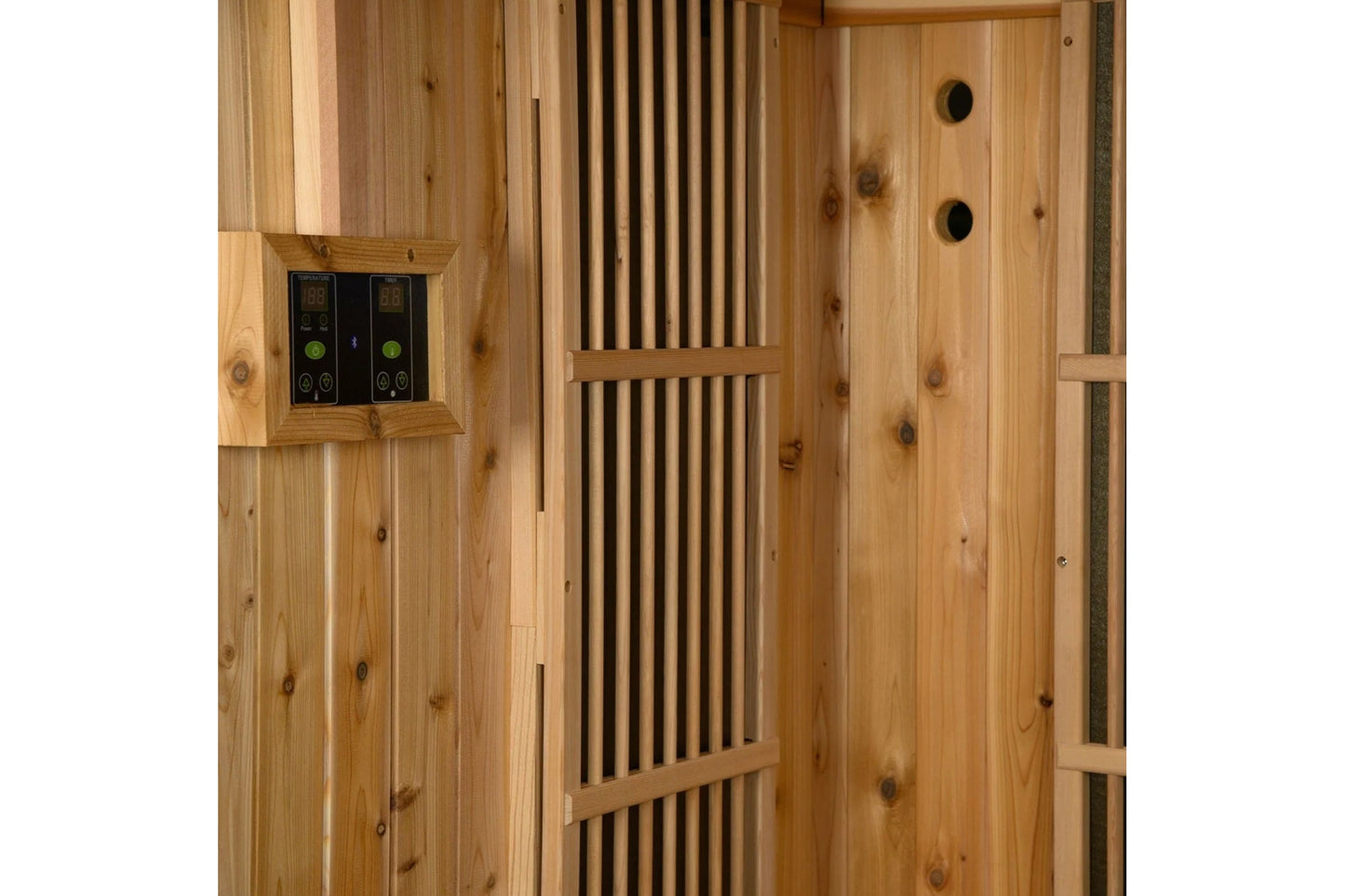 Cedar wood sauna interior with dual digital temperature controls, ventilation slats, and two circular air vents on the right 
