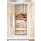Light wood sauna with glass door and metal frame, person relaxing inside on wooden benches, overhead view
