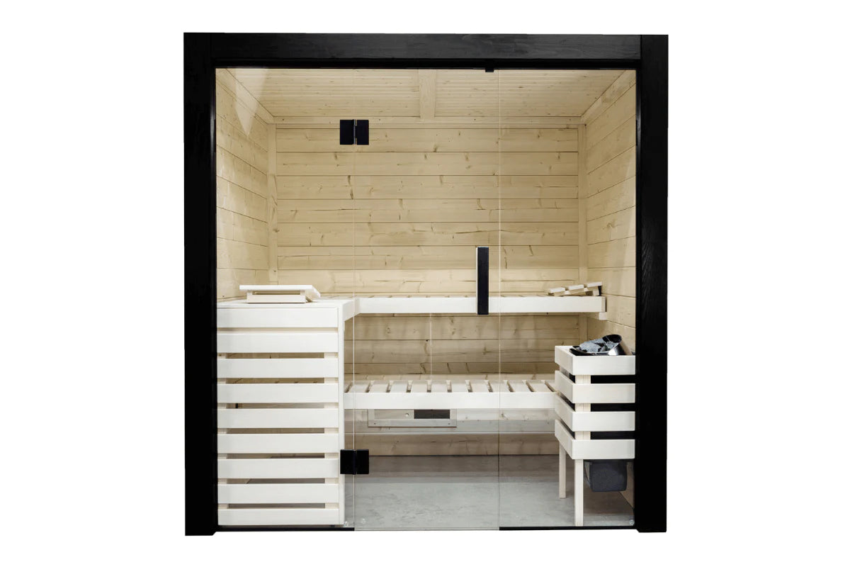 Almost Heaven Nordik indoor sauna with light wood construction, glass door, white and natural wood benches, black heater cont