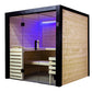 Black framed indoor sauna with glass doors, cedar wood interior, purple mood lighting, wooden benches, and light wood exterio