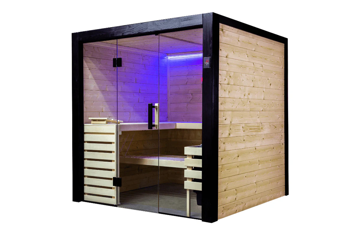 Black framed indoor sauna with glass doors, cedar wood interior, purple mood lighting, wooden benches, and light wood exterio